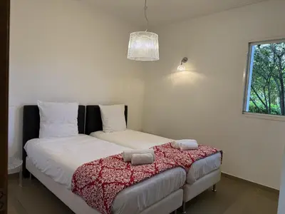 a bedroom with a bed and a window at T3 Cote Plage n 19 by Pinarello Villa Services in Pinarellu