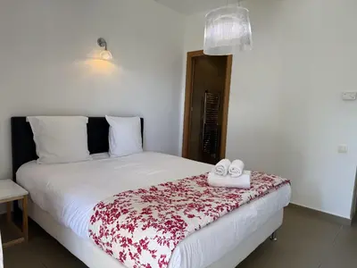 a bedroom with a bed with two shoes on it at T3 Cote Plage n 19 by Pinarello Villa Services in Pinarellu