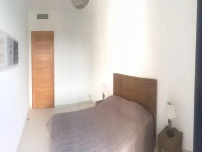 a bedroom with a bed and a wooden door at Marina di Fiori by Pinarello Villa Services in Furoli