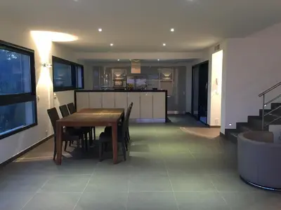 a dining room and kitchen with a table and chairs at Marina di Fiori by Pinarello Villa Services in Furoli