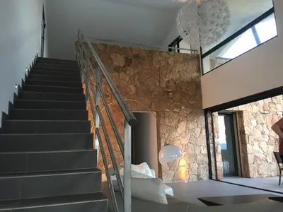 a room with stairs and a stone wall at Marina di Fiori by Pinarello Villa Services in Furoli