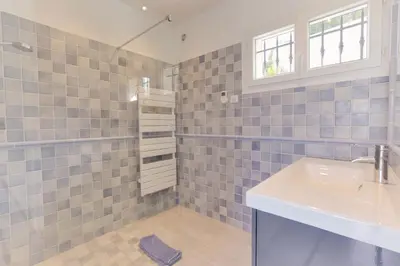 a bathroom with a sink and a shower at Padulaccia by Pinarello Villa Services in Pinarellu