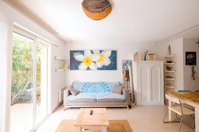 a living room with a couch and a table at Villa ALOHA pool-beach 500m in Santa-Maria-Poggio