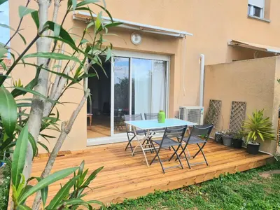 a patio with a table and chairs on a wooden deck at Villa ALOHA pool-beach 500m in Santa-Maria-Poggio