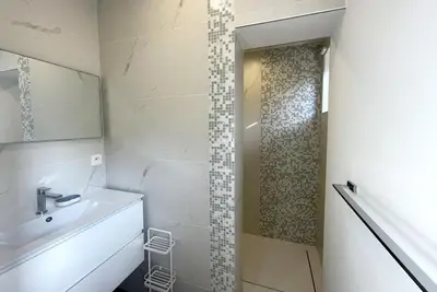 a bathroom with a sink and a shower at Villa Alta Vista in Porto-Vecchio