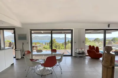 a kitchen and dining room with a table and chairs at Villa Alta Vista in Porto-Vecchio
