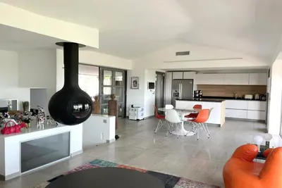 a kitchen and living room with a stove in it at Villa Alta Vista in Porto-Vecchio