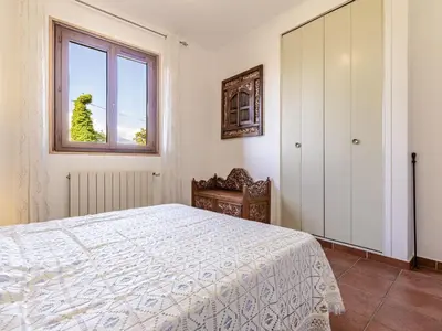 a bedroom with a bed and a window at Holiday Home Casa Féminiccia by Interhome in Ghisonaccia
