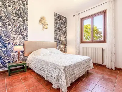 a bedroom with a bed and a window at Holiday Home Casa Féminiccia by Interhome in Ghisonaccia
