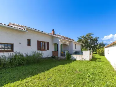 an old white house with a green yard at Holiday Home Casa Féminiccia by Interhome in Ghisonaccia