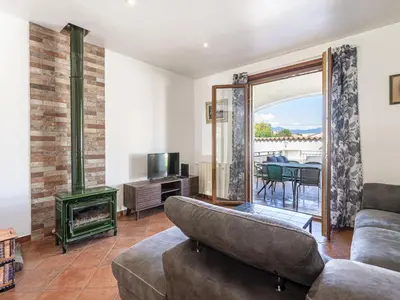 a living room with a couch and a fireplace at Holiday Home Casa Féminiccia by Interhome in Ghisonaccia
