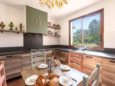 a kitchen with a table with bread on it at Holiday Home Casa Féminiccia by Interhome in Ghisonaccia