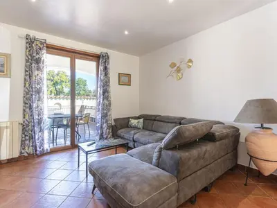a living room with a couch and a table at Holiday Home Casa Féminiccia by Interhome in Ghisonaccia