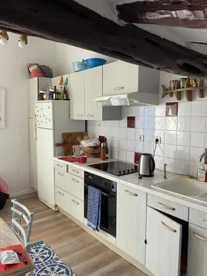 a kitchen with white cabinets and a stove top oven at Serenita - WiFi, Vue Mer, Central in Bonifacio