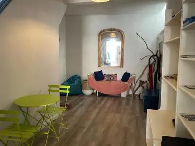 a living room with a hammock and a table and chairs at Serenita - WiFi, Vue Mer, Central in Bonifacio