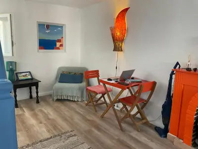 a room with a desk with a laptop and chairs at Serenita - WiFi, Vue Mer, Central in Bonifacio