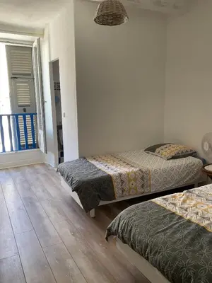 a bedroom with two beds and a window at Serenita - WiFi, Vue Mer, Central in Bonifacio