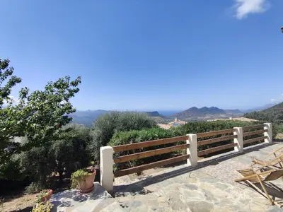 a white bench sitting on top of a hill at Casa Orsu vue panoramique in Poggio-dʼOletta