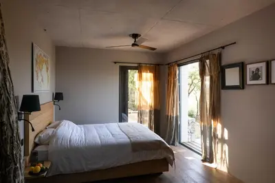 a bedroom with a bed and a large window at Ecodomaine & Distillerie U Viaghju in Muro