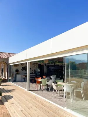 a patio with tables and chairs on a deck at T2 Saint Cyprien proche de la mer in Lecci