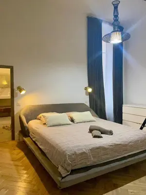 a bedroom with a bed with a blue window at 120 m2, hyper centre cathédrale proximité plage in Ajaccio