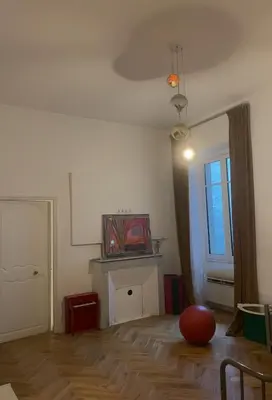 a living room with a red ball on the floor at 120 m2, hyper centre cathédrale proximité plage in Ajaccio