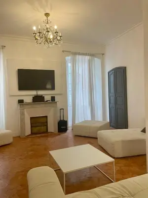 a living room with a fireplace and a tv at 120 m2, hyper centre cathédrale proximité plage in Ajaccio
