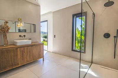 a bathroom with a sink and a glass shower at Villa MARE E MACCHIA in Lecci