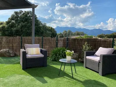two chairs and a table on a lawn at Valle Di Casa in Sotta