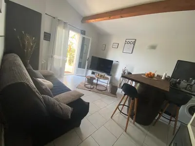 a living room with a couch and a table at Maison T3 in Piana