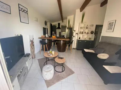 a living room with a couch and a table at Maison T3 in Piana