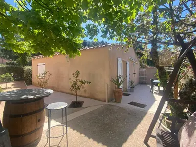 a patio with a table and chairs and a building at Maison T3 in Piana
