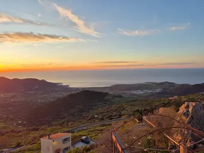a view of the ocean from a hill with the sunset at Superbe Maison de village authentique vue mer in SantʼAntonino