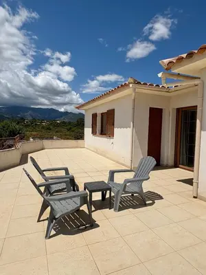 two chairs and a table on a patio at Villa avec piscine à Lecci in Lecci