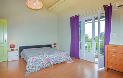 a bedroom with a bed with purple curtains at Villa Piscine Privée in Moriani Plage