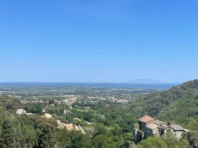 an old building on top of a hill with trees at Charming apartment in Corsican Village in Vescovato