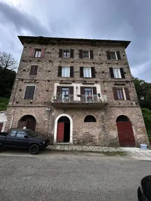 a building with a car parked in front of it at Charming apartment in Corsican Village in Vescovato