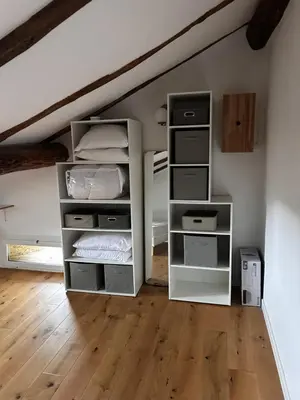 a room with an attic with white shelves at Charming apartment in Corsican Village in Vescovato