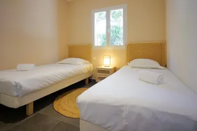 two twin beds in a room with a window at Résidence Casa di Sole in Sotta