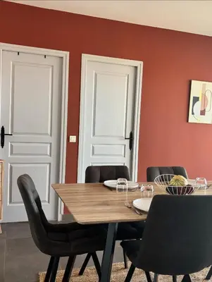 a dining room with white doors and a table and chairs at Résidence Casa di Sole in Sotta