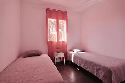 two beds in a small room with a window at Résidence Casa di Sole in Sotta