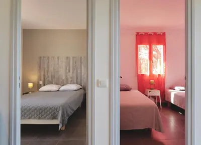 a bedroom with two beds and a red window at Résidence Casa di Sole in Sotta