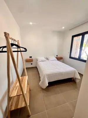 a bedroom with a bed and a ladder in it at Maison Di Fiori, location neuve avec piscine in Porto-Vecchio
