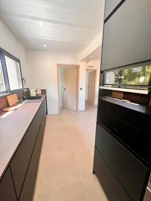a kitchen with a sink and a counter top at Maison Di Fiori, location neuve avec piscine in Porto-Vecchio