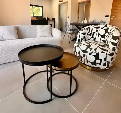 a living room with a couch and a table and a chair at Maison Di Fiori, location neuve avec piscine in Porto-Vecchio