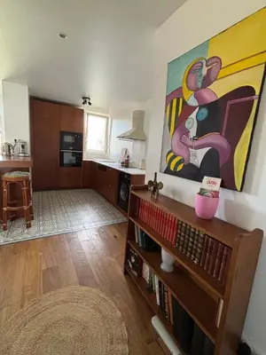 a living room with a large painting on the wall at Confort et modernité Ajaccio in Ajaccio