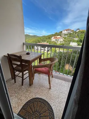 a balcony with a table and chairs and a view at Confort et modernité Ajaccio in Ajaccio