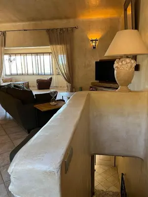 a living room with a table with a vase on it at Villa Ghjulia in Porto-Vecchio