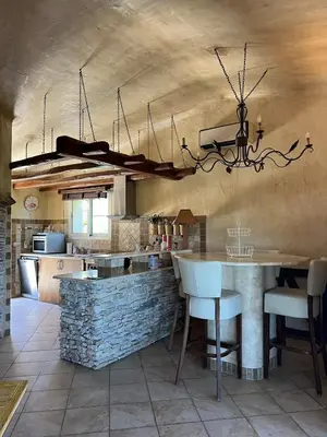 a kitchen with a table and chairs in a room at Villa Ghjulia in Porto-Vecchio