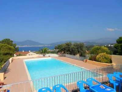 a swimming pool with blue chairs and the water at T2 log entier Porticcio 35m piscine-mer-resto 400m in Grosseto-Prugna